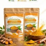 Two pouches of Seraphic Sun Lakadong Turmeric Powder on a wooden surface with raw turmeric roots and a bowl of loose powder, featuring labels for 100% pure, high curcumin, and natural.